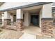 Inviting front porch with stone pillars, a welcoming blue door, and decorative accents for a cozy appeal at 3241 E Aris Dr, Gilbert, AZ 85298