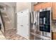 Stainless steel LG refrigerator next to stairs with wood look floors at 3241 E Aris Dr, Gilbert, AZ 85298
