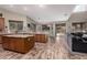 Open kitchen and eating area with wood floors, large island, and sliding glass doors to the yard at 3241 E Aris Dr, Gilbert, AZ 85298
