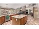 Open kitchen with granite countertops, stainless steel appliances, and breakfast bar, flowing into the living room at 3241 E Aris Dr, Gilbert, AZ 85298