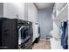 Convenient laundry room with modern washer and dryer, ample storage, and bright lighting at 3241 E Aris Dr, Gilbert, AZ 85298
