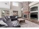 Spacious living room featuring a stone fireplace, lots of natural light, and a large couch at 3241 E Aris Dr, Gilbert, AZ 85298