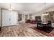 Open-concept living area features elegant wood-look flooring, plantation shutters, and comfortable seating at 3241 E Aris Dr, Gilbert, AZ 85298