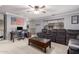 Open-concept living space with a large sectional sofa, ceiling fan, and desk area at 3241 E Aris Dr, Gilbert, AZ 85298