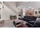 Inviting living room featuring a staircase, hardwood floors, and comfortable seating adjacent to a kitchen at 3241 E Aris Dr, Gilbert, AZ 85298
