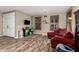 Bright living room with wood floors, red couches, window shutters, and playful decor at 3241 E Aris Dr, Gilbert, AZ 85298