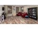 Cozy living room with wood-look floors, plantation shutters, and comfortable seating arrangement at 3241 E Aris Dr, Gilbert, AZ 85298