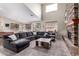 Bright living room with high ceiling, stone fireplace, lots of natural light, and a large couch at 3241 E Aris Dr, Gilbert, AZ 85298