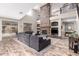 Bright living room boasts a soaring stone fireplace, wood floors, and a comfortable seating arrangement at 3241 E Aris Dr, Gilbert, AZ 85298