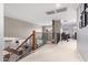Open loft with wrought iron railing, neutral colors, and a view of the living spaces below at 3241 E Aris Dr, Gilbert, AZ 85298