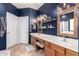 Bathroom featuring dual sinks, vanity area, and wood-framed mirrors at 3241 E Aris Dr, Gilbert, AZ 85298