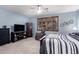 Bright main bedroom featuring a ceiling fan and large dresser with TV at 3241 E Aris Dr, Gilbert, AZ 85298