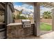 Outdoor kitchen featuring a built-in grill and stone counter, perfect for entertaining at 3241 E Aris Dr, Gilbert, AZ 85298