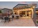 Spacious outdoor living area with pergola, string lights, outdoor seating, and a built-in kitchen and grill at 3241 E Aris Dr, Gilbert, AZ 85298