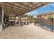 Spacious backyard patio features a built-in bar, seating, and a covered pergola with string lights at 3241 E Aris Dr, Gilbert, AZ 85298