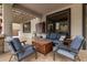 Covered patio with cozy seating, wooden table, and neutral tones offers a relaxing outdoor living space at 3241 E Aris Dr, Gilbert, AZ 85298