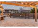 Backyard pool with safety fence, adjacent to outdoor dining area, and mature trees at 3241 E Aris Dr, Gilbert, AZ 85298