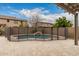Backyard pool with black safety fence and desert landscaping offers a private oasis for relaxation at 3241 E Aris Dr, Gilbert, AZ 85298