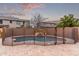 Beautiful backyard pool with rock waterfall feature and secure safety fence, surrounded by desert landscaping at 3241 E Aris Dr, Gilbert, AZ 85298