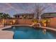 Tranquil backyard pool with desert landscaping and cascading rock feature offers a private outdoor retreat at 3241 E Aris Dr, Gilbert, AZ 85298