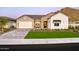 Stunning curb appeal with a two-car garage and landscaped lawn at 33608 N Maverick Mountain Trl, San Tan Valley, AZ 85144