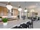 Open kitchen with island, breakfast bar, and stainless steel appliances at 33608 N Maverick Mountain Trl, San Tan Valley, AZ 85144