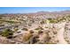 Expansive aerial view of a golf community with lush green fairways, desert landscaping and mountain views at 514 S 224Th Dr, Buckeye, AZ 85326