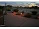 Desert landscaping with low lighting illuminates the backyard at night at 514 S 224Th Dr, Buckeye, AZ 85326