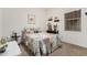 Guest bedroom with a comfortable bed and window with mini blinds at 514 S 224Th Dr, Buckeye, AZ 85326