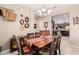 Open dining room with view into kitchen, showcasing a rustic wooden table at 514 S 224Th Dr, Buckeye, AZ 85326