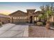 Inviting single-story home featuring a two-car garage, desert landscaping, and a covered entryway at 514 S 224Th Dr, Buckeye, AZ 85326