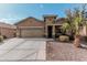 Single-story home with two-car garage and desert landscaping at 514 S 224Th Dr, Buckeye, AZ 85326