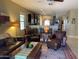 Spacious living room featuring a comfortable leather seating arrangement and views into the kitchen area at 514 S 224Th Dr, Buckeye, AZ 85326