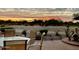 Peaceful patio setting at sunset with outdoor furniture and fire pit at 514 S 224Th Dr, Buckeye, AZ 85326