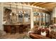 Rustic bar with leather seating and access to outdoor patio at 5526 E Roadrunner Rd, Paradise Valley, AZ 85253