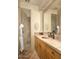 Comfortable bathroom featuring natural stone countertops, a shower stall, and a warm aesthetic at 5526 E Roadrunner Rd, Paradise Valley, AZ 85253