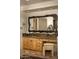 Charming bathroom with wooden cabinets, granite countertops, and a decorative mirror at 5526 E Roadrunner Rd, Paradise Valley, AZ 85253