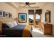 Bright bedroom with doors to a balcony, views of the mountains, and stylish décor at 5526 E Roadrunner Rd, Paradise Valley, AZ 85253