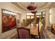 Elegant dining room with large artwork and rustic wood dining table at 5526 E Roadrunner Rd, Paradise Valley, AZ 85253