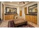 Gorgeous main bathroom with dual vanities, decorative mirrors, an ottoman, and designer accents at 5526 E Roadrunner Rd, Paradise Valley, AZ 85253