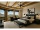 Bright main bedroom with exposed beams, ceiling fan, and stunning mountain views at 5526 E Roadrunner Rd, Paradise Valley, AZ 85253