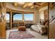 Beautiful main bedroom features exposed wood beam ceiling, accent rug, and spectacular views at 5526 E Roadrunner Rd, Paradise Valley, AZ 85253