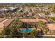 Community pool and surrounding buildings are shown in this aerial view at 5550 N 16Th St # 102, Phoenix, AZ 85016