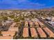 Aerial view of a community with multiple buildings, parking, and mountain views at 5550 N 16Th St # 102, Phoenix, AZ 85016