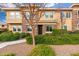 Tan two-story townhome with stone accents and landscaping at 5550 N 16Th St # 102, Phoenix, AZ 85016