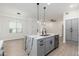 Modern kitchen with gray island, marble countertop and stainless steel appliances at 5550 N 16Th St # 102, Phoenix, AZ 85016