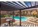 Community pool with pergola, grill, and seating at 5550 N 16Th St # 102, Phoenix, AZ 85016