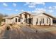 Desert landscape surrounds this charming one-story home with a terracotta tile roof and arched entryway at 900 Cacti Verde --, Wickenburg, AZ 85390