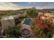 Aerial view of home showcasing pool, landscaping, and mountains at 9950 E Sundance Trl, Scottsdale, AZ 85262