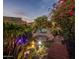 Landscaped backyard with pool, pond, bridge, and string lights at 9950 E Sundance Trl, Scottsdale, AZ 85262